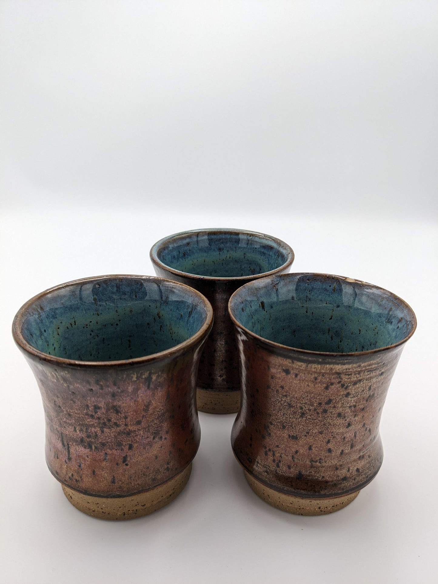 3 Copper-colored stoneware tumblers