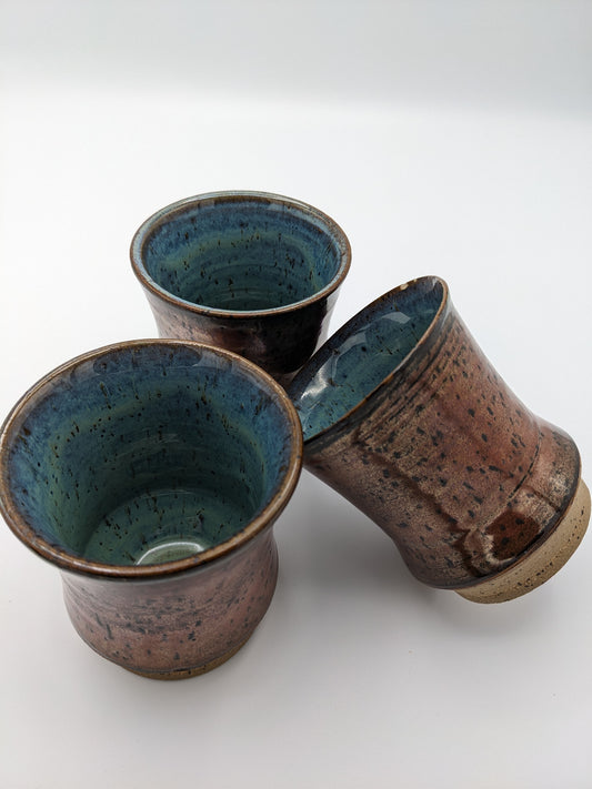 3 Copper-colored stoneware tumblers