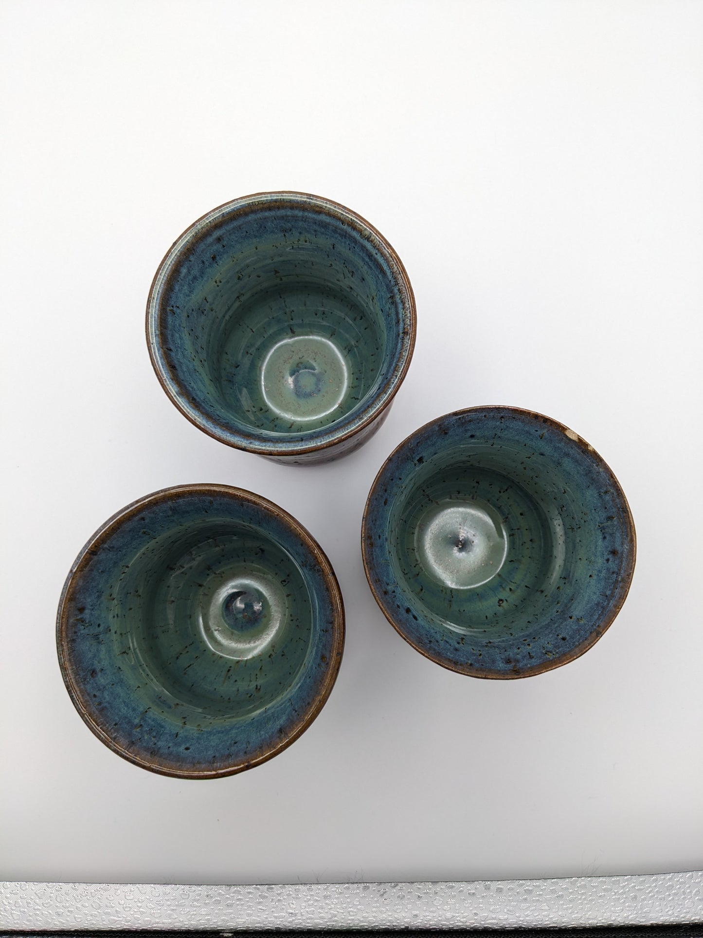 3 Copper-colored stoneware tumblers